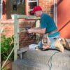 Volunteer repairing front steps